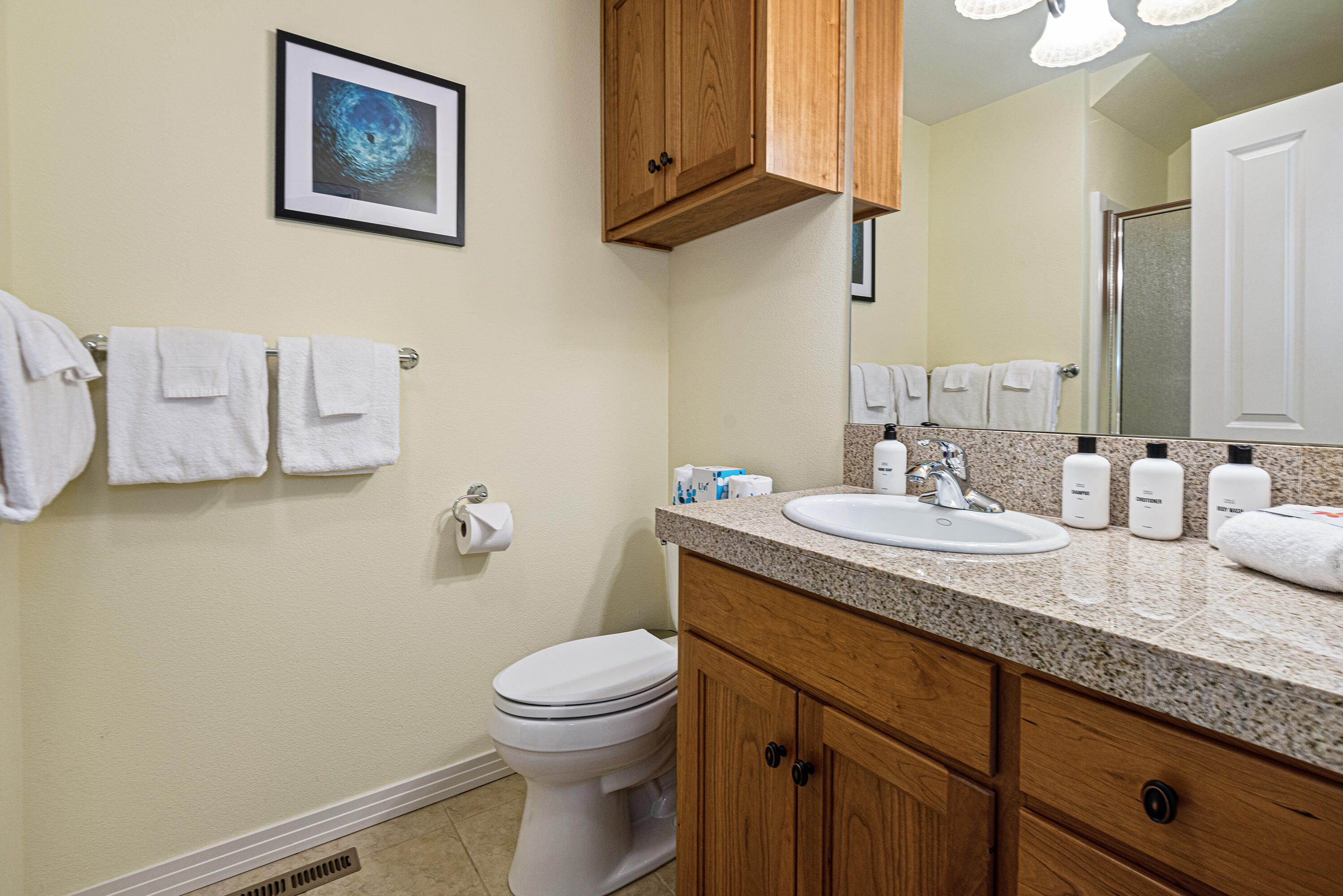 16775 Pony Express Way Bend, OR 97707 - Photo 25 of 38 a bathroom with a granite countertop sink and a toilet