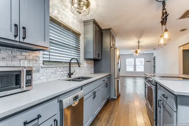 a kitchen with a sink stove and cabinets