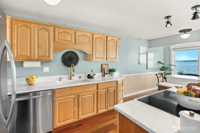 a kitchen with a sink stove and cabinets