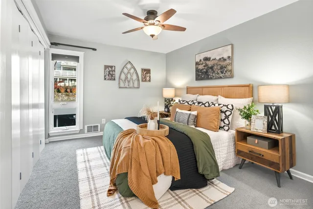 a spacious bedroom with two beds and a lamp