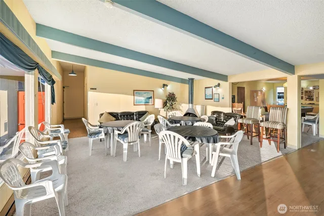 a view of a dining room with furniture a chandelier and wooden floor