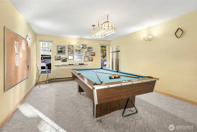 a room with pool table and windows
