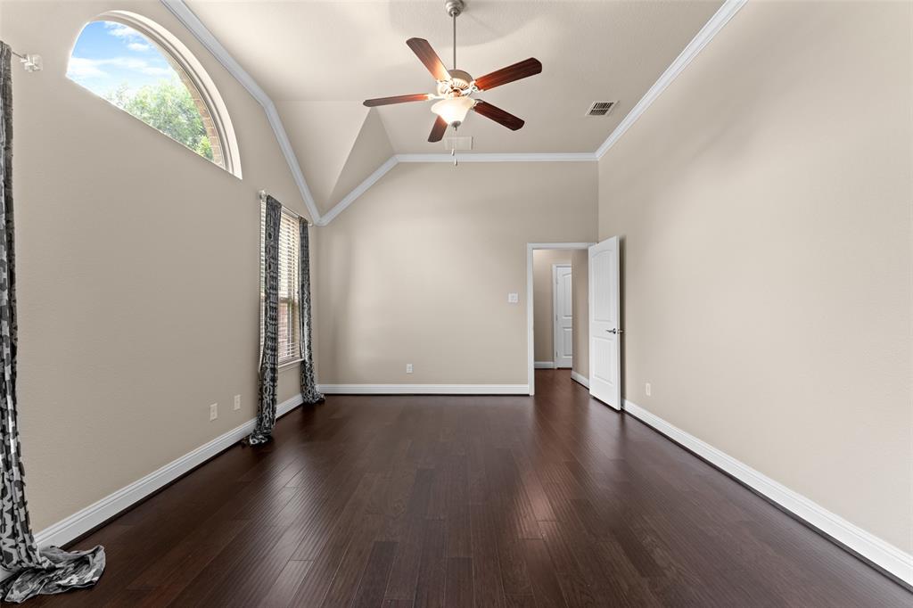 600 Fishback Circle Plano, TX 75074 - Photo 13 of 38 an empty room with wooden floor chandelier fan and windows