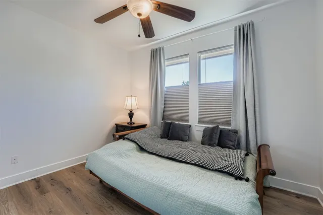 a bedroom with a large bed and a window