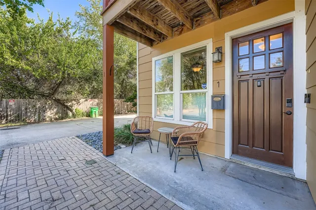 a view of a patio with table and chairs