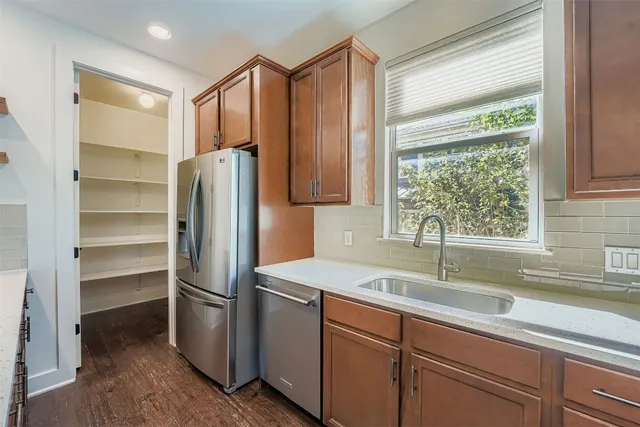 a kitchen with a refrigerator and a sink