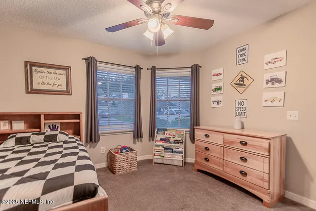 a bedroom with furniture and a window