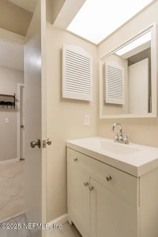 a bathroom with a sink a toilet a mirror and