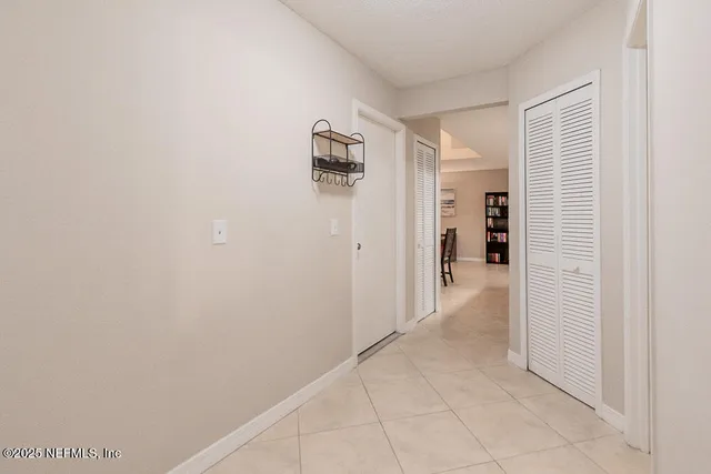 a view of a hallway with wooden shelves