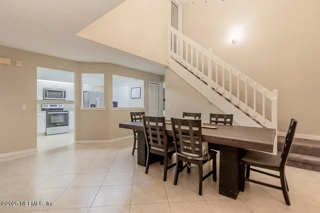 a dining room with furniture and entryway