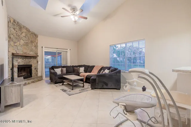 a living room with furniture and a fireplace