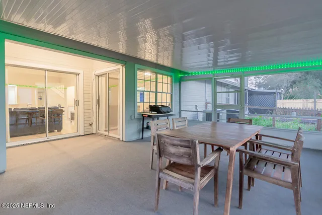 a dining room with furniture and a garden