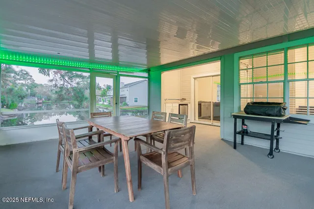 a backyard of a house with barbeque oven and seating space