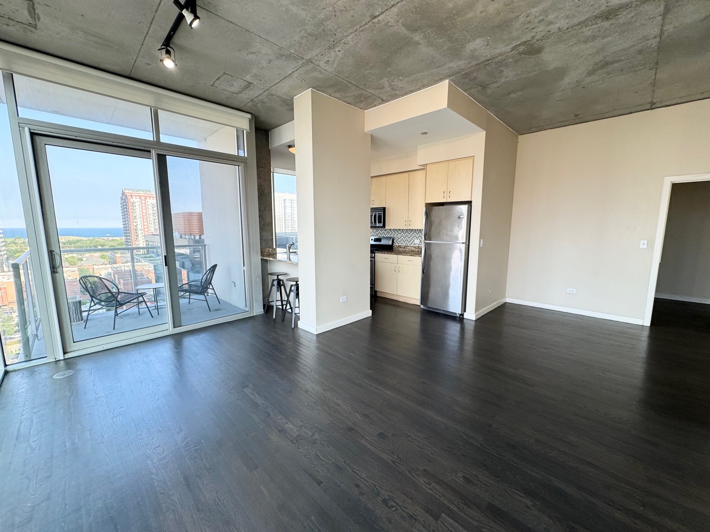1720 South Michigan Avenue, Unit 1401 Chicago, IL 60616 - Photo 3 of 13 a view of a big room with wooden floor and windows