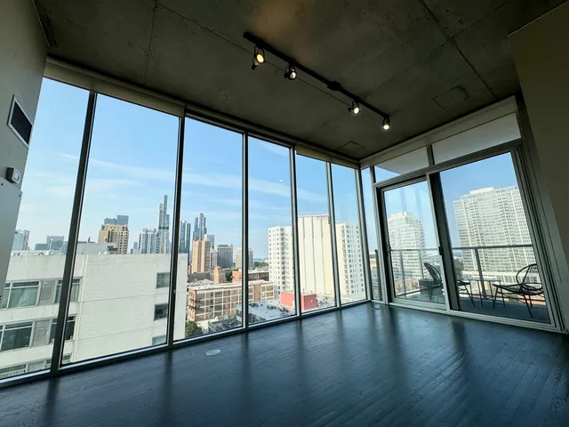 a view of an empty room with large windows