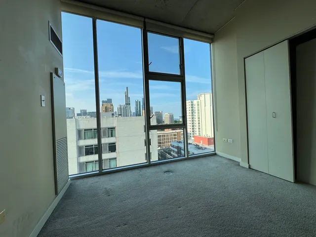 an empty room with windows and balcony view