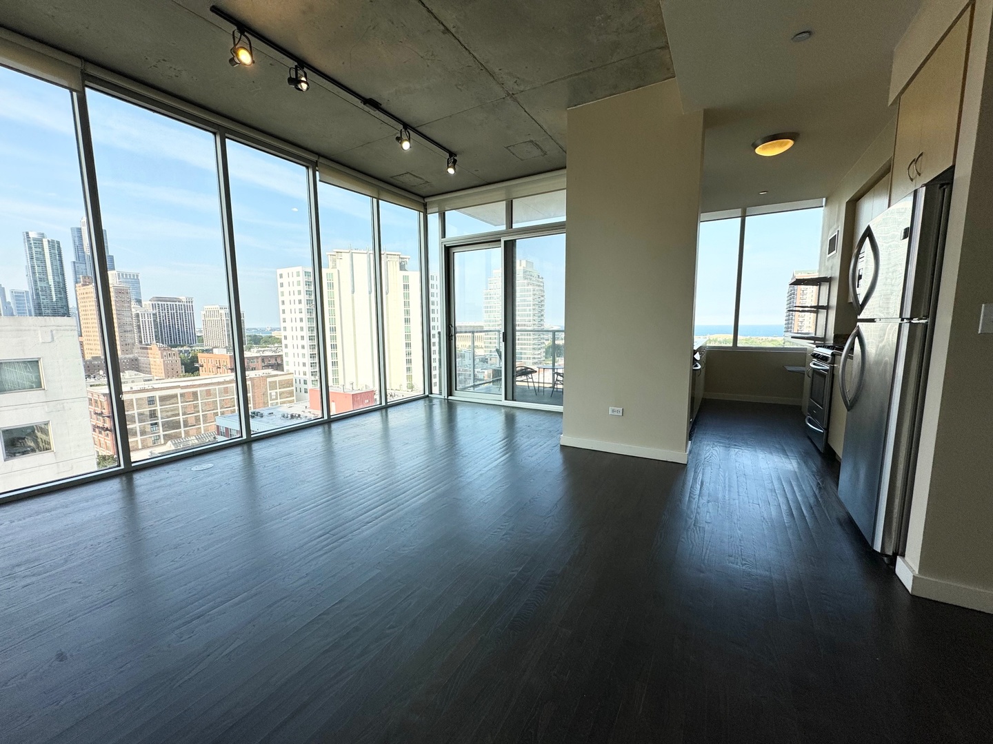 1720 South Michigan Avenue, Unit 1401 Chicago, IL 60616 - Photo 9 of 13 a view of an empty room with wooden floor and a window