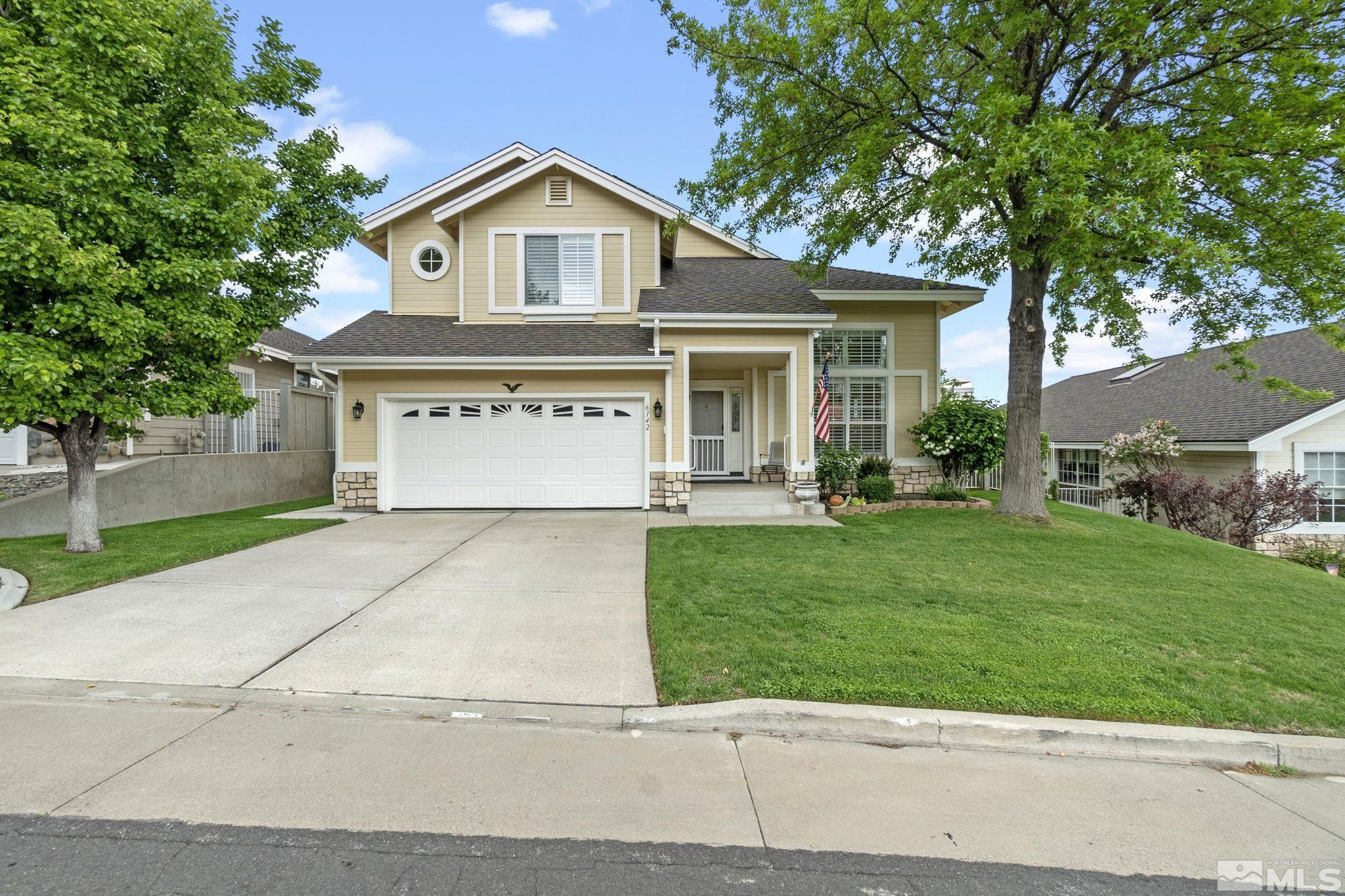 6142 Carriage House Way Reno, NV 89519 - Photo 1 of 40 a front view of a house with a yard and garage