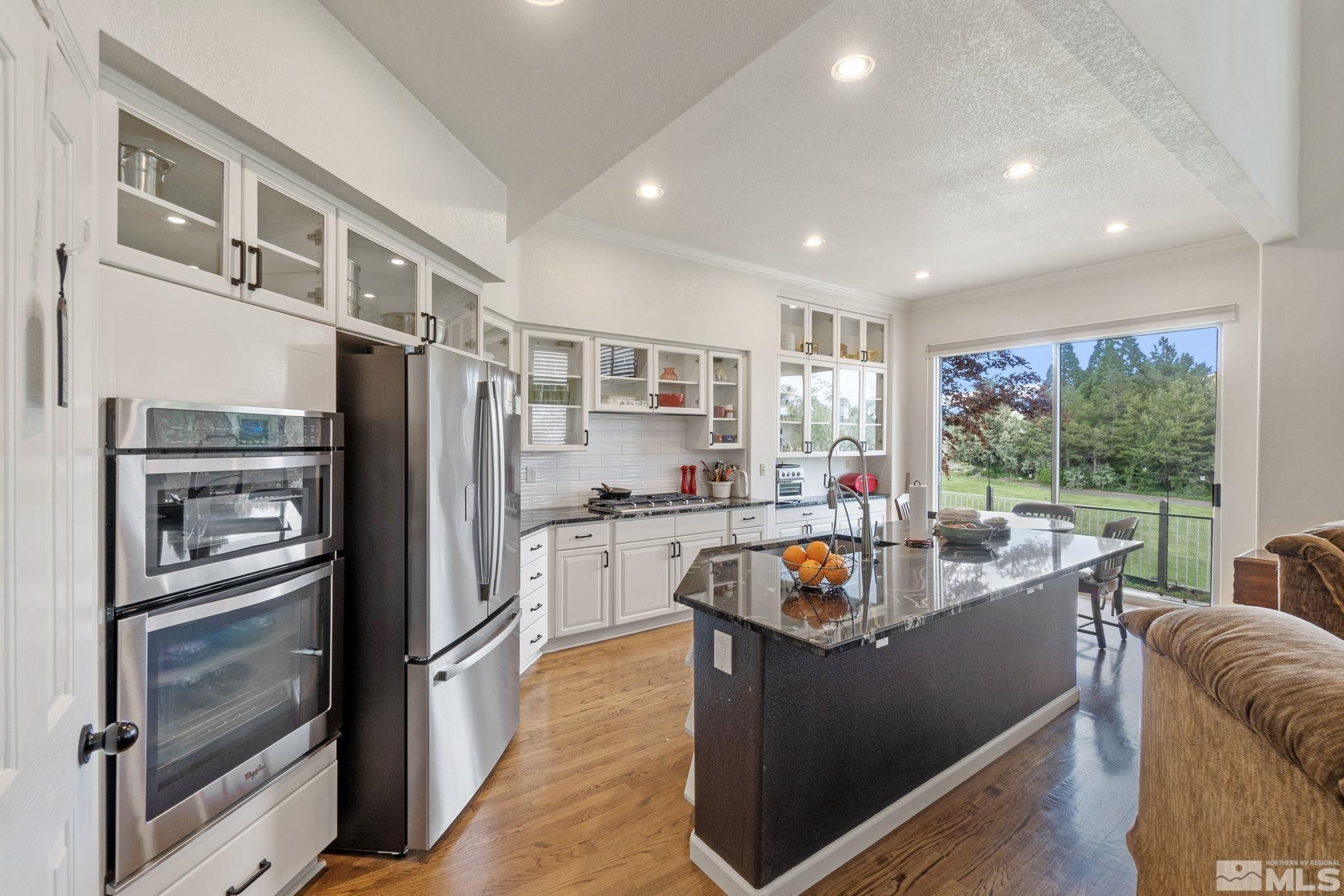 6142 Carriage House Way Reno, NV 89519 - Photo 20 of 40 a kitchen with stainless steel appliances granite countertop a refrigerator and a stove