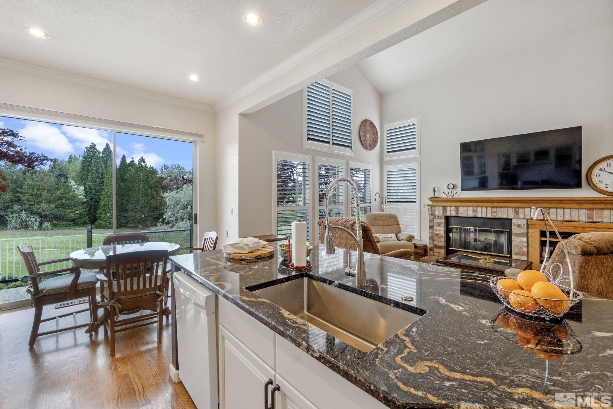 6142 Carriage House Way Reno, NV 89519 - Photo 23 of 40 a kitchen with granite countertop a stove and a sink
