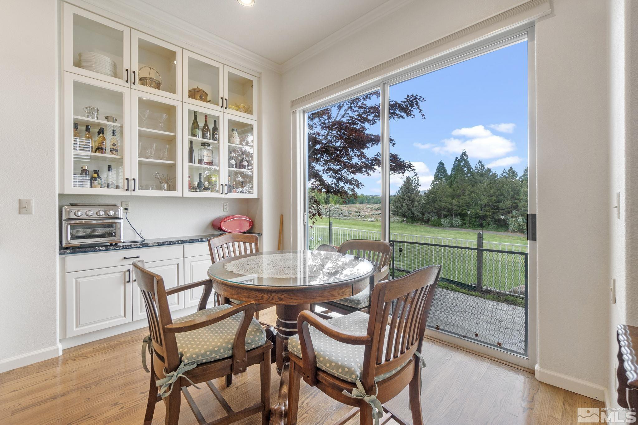 6142 Carriage House Way Reno, NV 89519 - Photo 24 of 40 a dining room with furniture and a floor to ceiling window