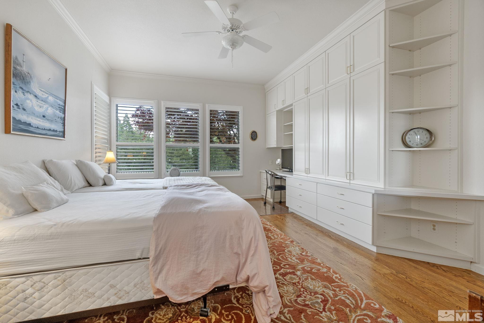 6142 Carriage House Way Reno, NV 89519 - Photo 28 of 40 a spacious bedroom with a bed and glass windows