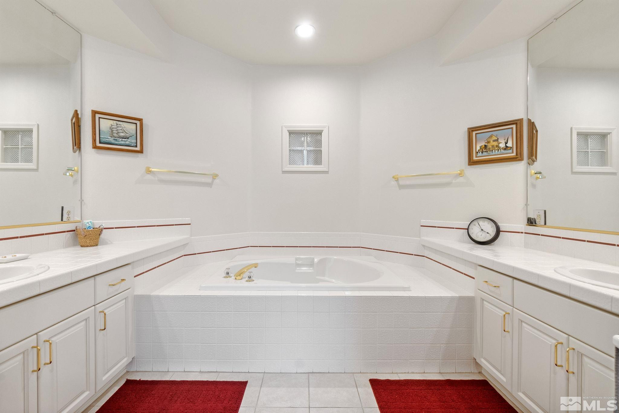 6142 Carriage House Way Reno, NV 89519 - Photo 29 of 40 a bathroom with a tub sink and mirror