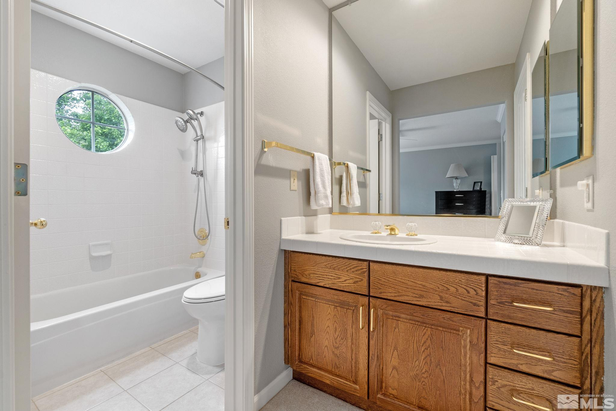 6142 Carriage House Way Reno, NV 89519 - Photo 34 of 40 a bathroom with a double vanity sink toilet and shower
