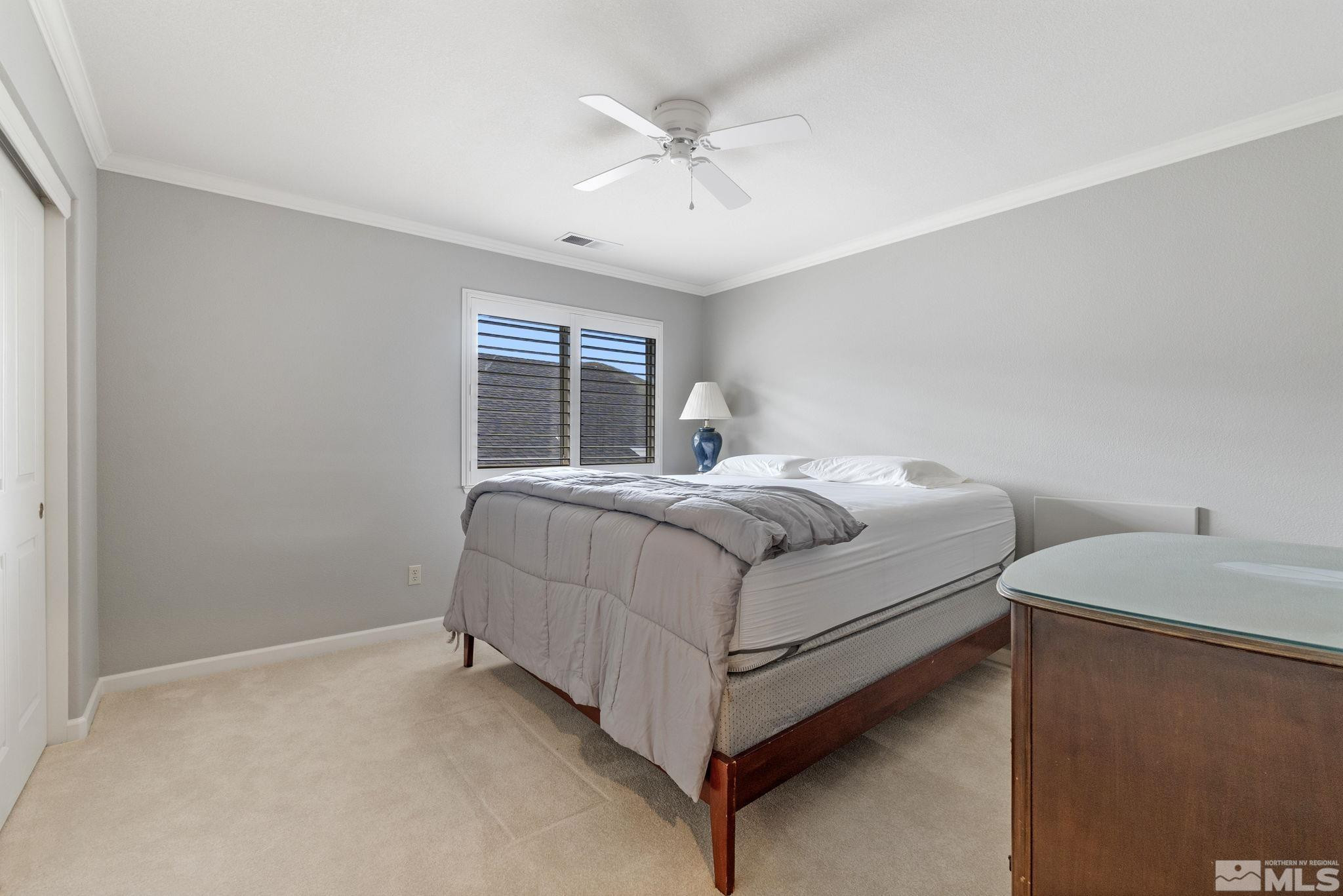 6142 Carriage House Way Reno, NV 89519 - Photo 35 of 40 a bedroom with a bed and a ceiling fan