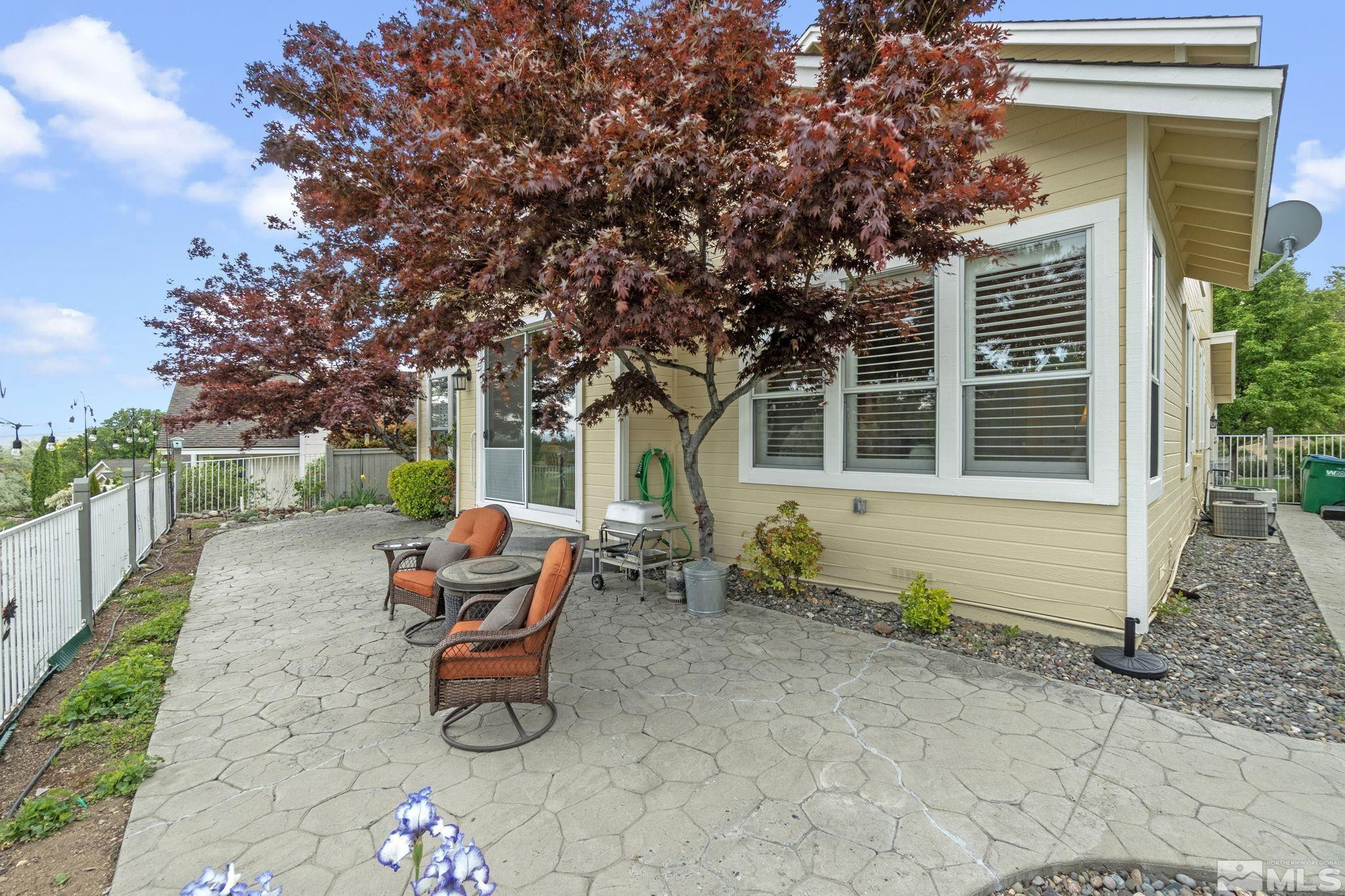 6142 Carriage House Way Reno, NV 89519 - Photo 39 of 40 a backyard of a house with barbeque oven table and chairs