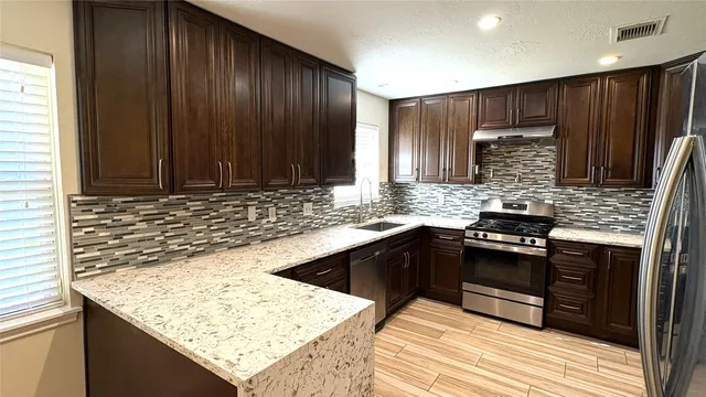 a stove top oven sitting inside of a kitchen