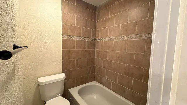 a view of a room with wooden floor and a window