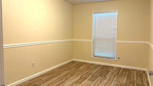 a view of a room with wooden floor