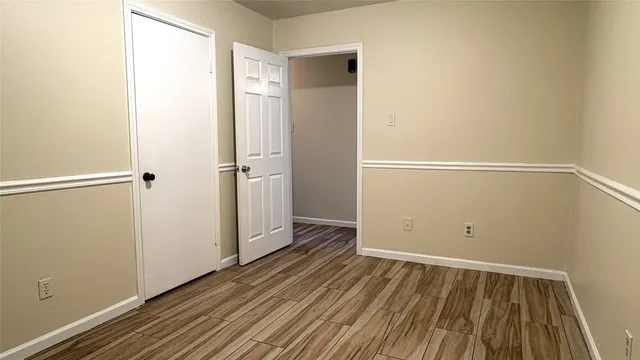 a yellow house sitting in middle of the middle of a yard