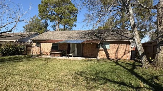 a view of backyard with wooden fence