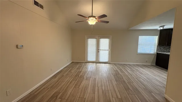 wooden floor in an empty room with a window