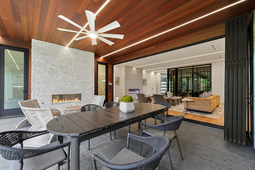 9457 Waterview Road Dallas, TX 75218 - Photo 13 of 25 Outdoor covered patio with a wood-paneled ceiling, integrated linear lighting, and a modern ceiling fan