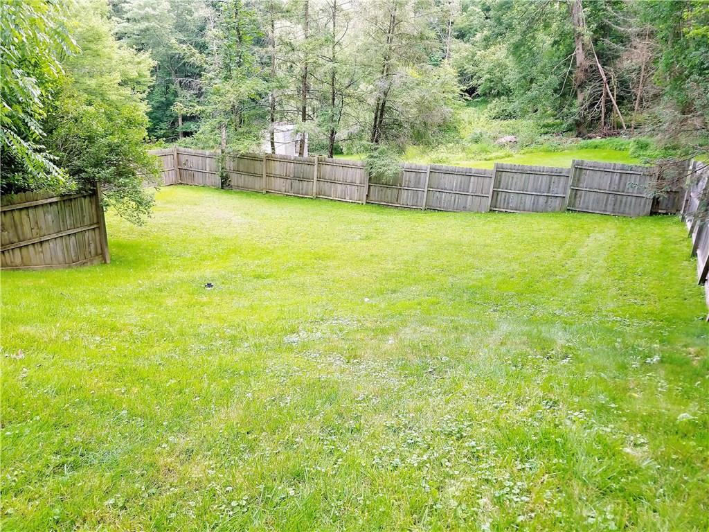 5424 Hardt Road Gibsonia, PA 15044 - Photo 20 of 24 Over 1/2 acre lot, partially fenced in. Property line goes into the woods in the back.