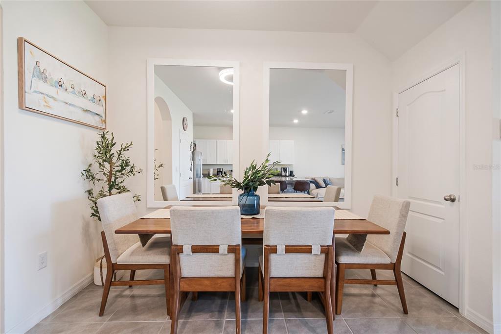 1359 Isleta Loop Kissimmee, FL 34741 - Photo 11 of 57 a view of a dining room with furniture and wooden floor