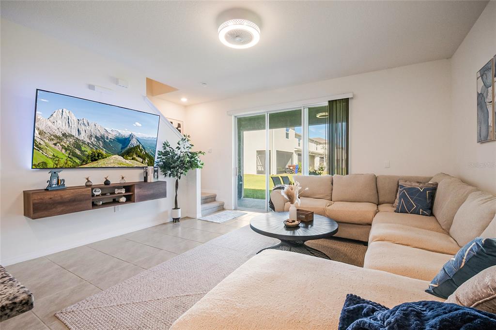 1359 Isleta Loop Kissimmee, FL 34741 - Photo 19 of 57 a living room with furniture and a flat screen tv
