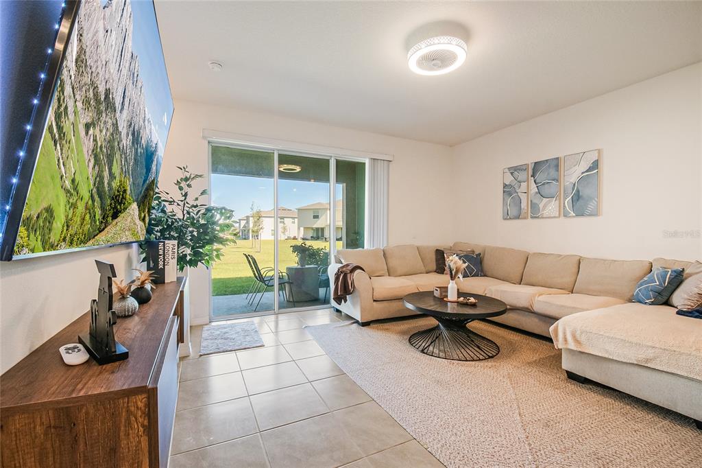 1359 Isleta Loop Kissimmee, FL 34741 - Photo 20 of 57 a living room with furniture and a potted plant