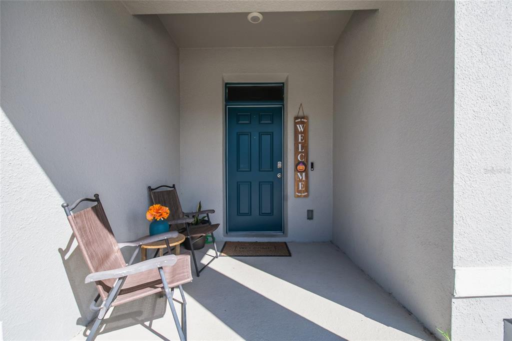 1359 Isleta Loop Kissimmee, FL 34741 - Photo 2 of 57 wooden floor and table in a hall with an entryway