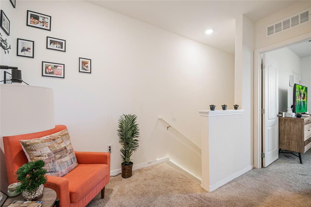 1359 Isleta Loop Kissimmee, FL 34741 - Photo 23 of 57 a living room with furniture and wooden floor