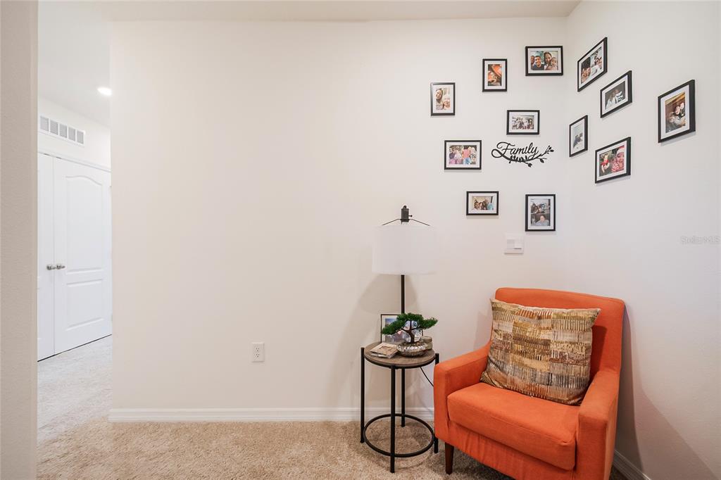 1359 Isleta Loop Kissimmee, FL 34741 - Photo 25 of 57 a bench sitting in a living room with a rug