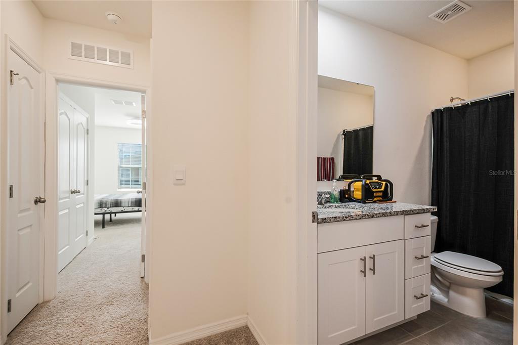 1359 Isleta Loop Kissimmee, FL 34741 - Photo 29 of 57 a bathroom with a toilet sink and mirror