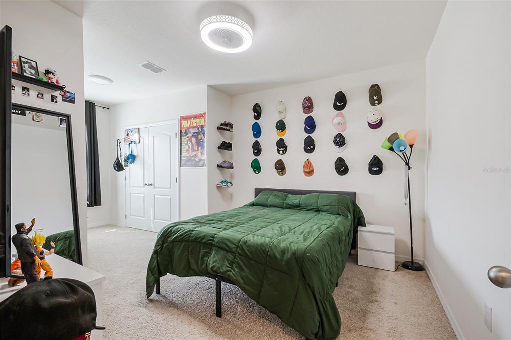 1359 Isleta Loop Kissimmee, FL 34741 - Photo 31 of 57 a bedroom with a bed and a painting on the wall