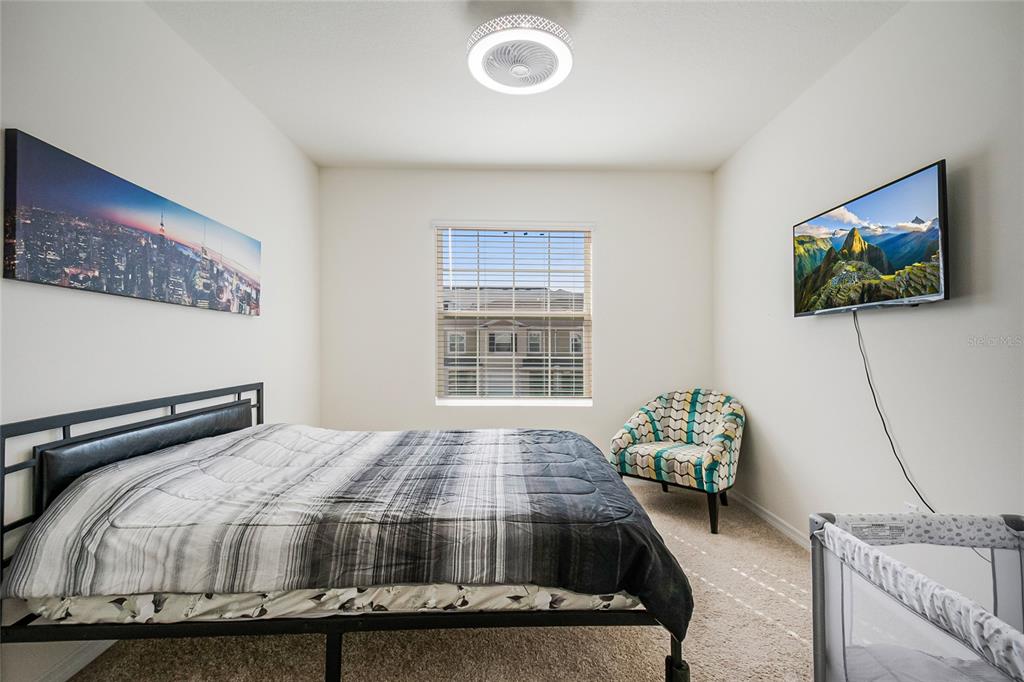 1359 Isleta Loop Kissimmee, FL 34741 - Photo 34 of 57 a bedroom with a bed and a flat screen tv