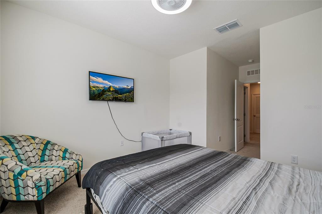 1359 Isleta Loop Kissimmee, FL 34741 - Photo 35 of 57 a bedroom with a bed and a painting on the wall