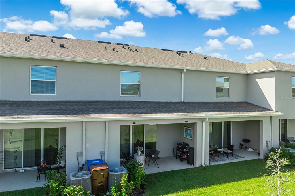 1359 Isleta Loop Kissimmee, FL 34741 - Photo 38 of 57 a view of a patio with table and chairs and potted plants