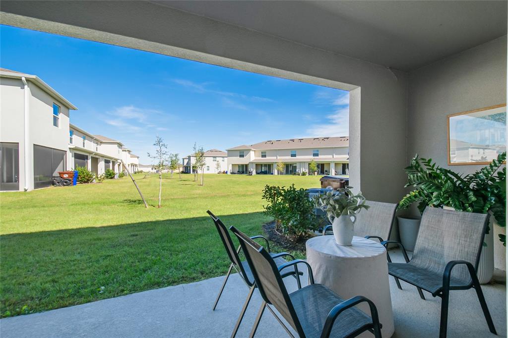 1359 Isleta Loop Kissimmee, FL 34741 - Photo 41 of 57 a view of a chairs and table in patio with a yard